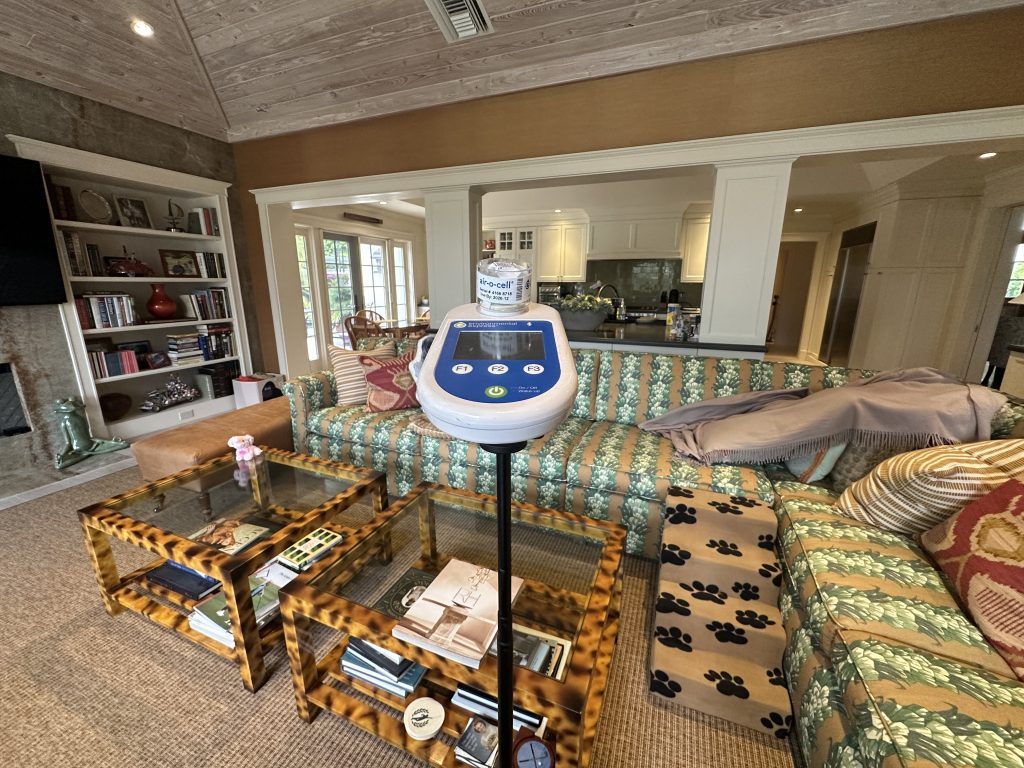 Indoor air quality testing device performing air sampling in luxury residential living room