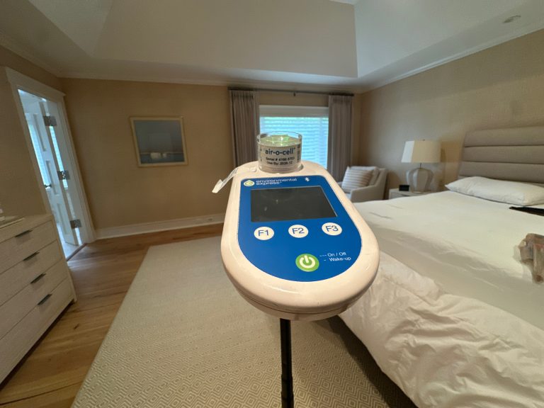 Air sampling device completing indoor air quality test in luxury bedroom