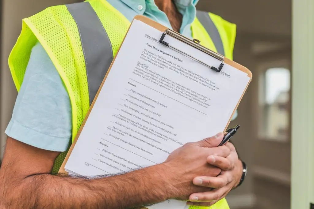 home inspector holding checklist reviewing mold inspection report Florida